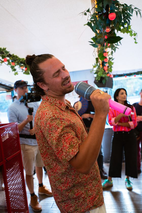 A guest singing into the mic during a Sing Along Moment